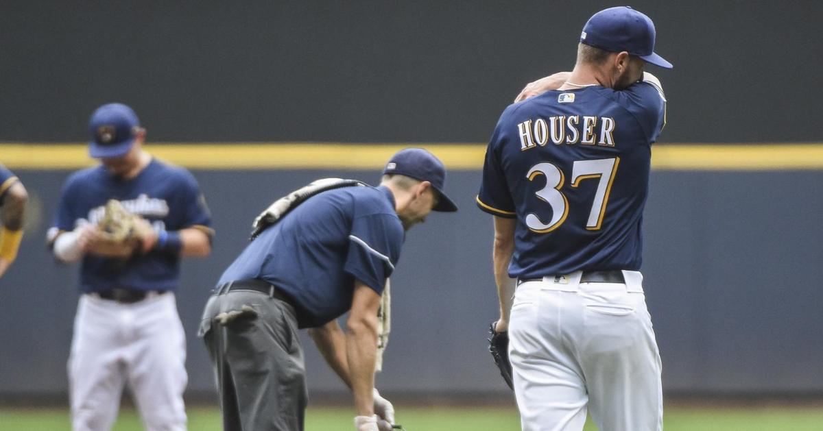 Milwaukee Brewers starting pitcher Adrian Houser puked during a game after committing a fielding error. (Benny Sieu-USA TODAY Sports)