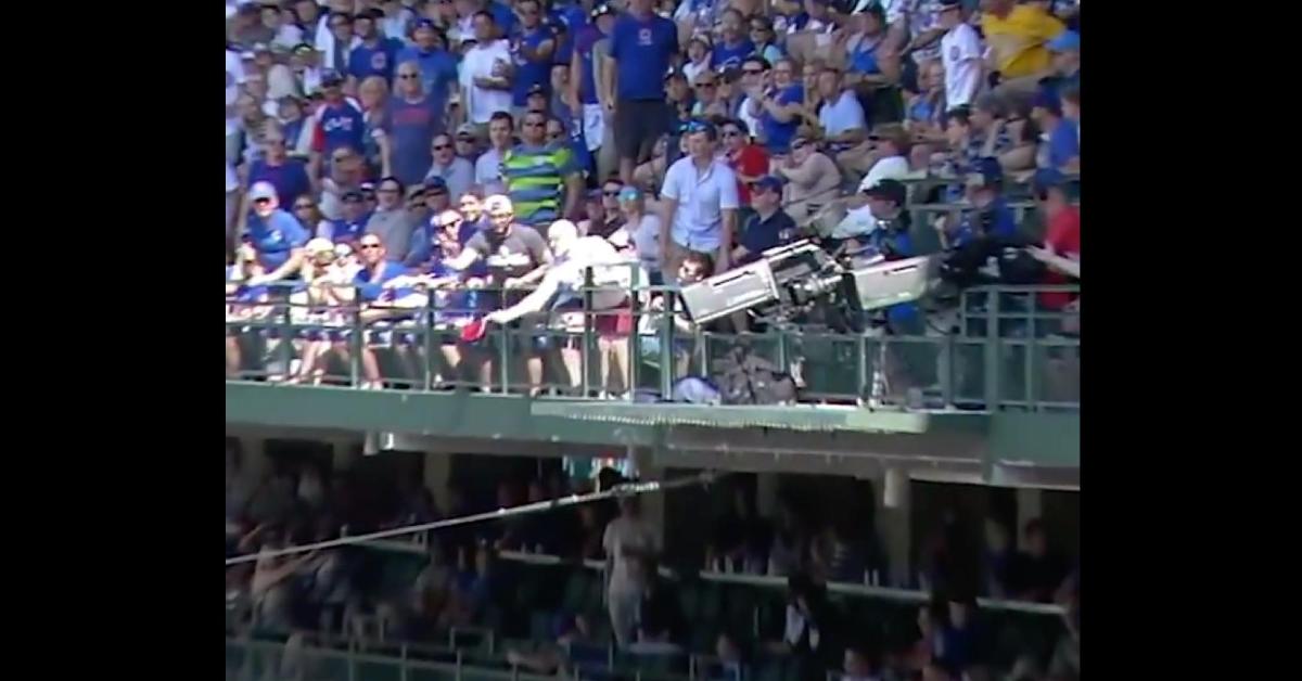This Cubs fan used his son's baseball cap as a baseball glove when catching a foul ball.