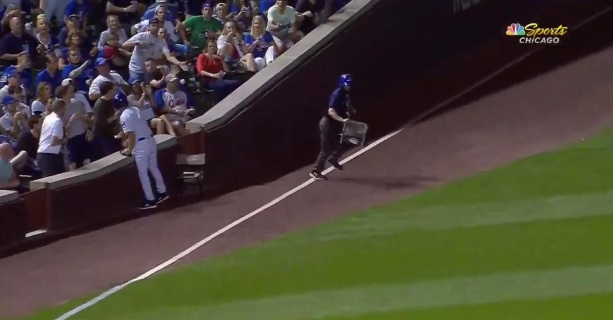 A distracted fan at Wrigley Field was lucky to avoid being drilled in the face by a bouncing foul ball.