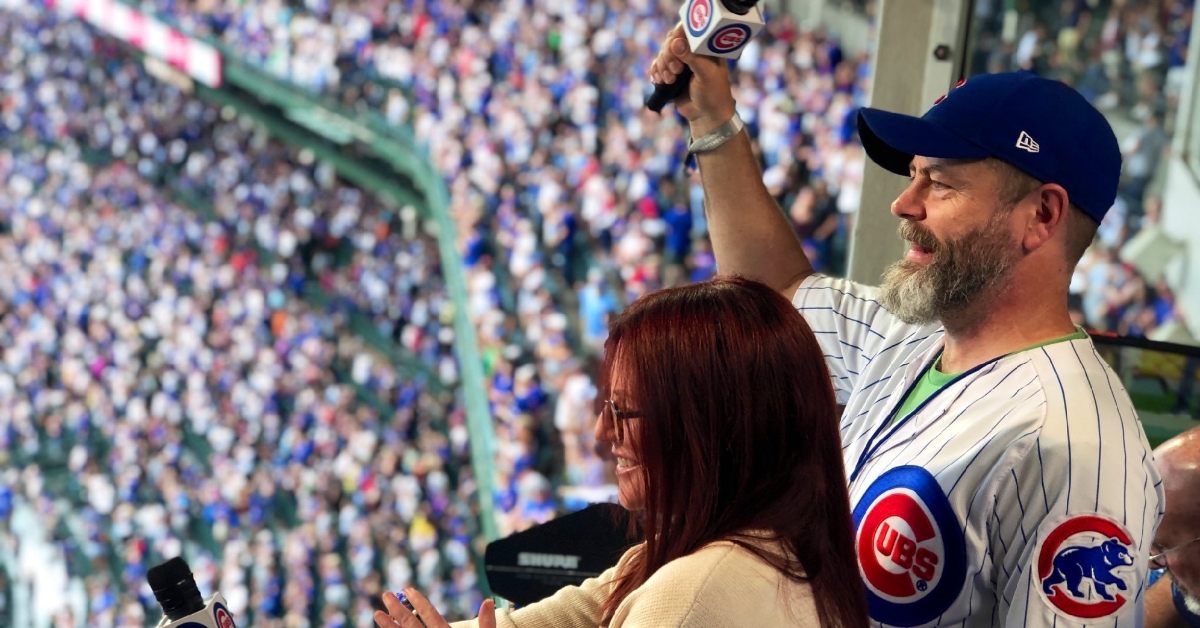 Megan Mullally and Nick Offerman sang out the seventh-inning stretch at Sunday's Cubs-Pirates game. (Credit: @Cubs on Twitter)