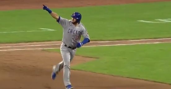 David Bote celebrates while he rounds the bases after his homer