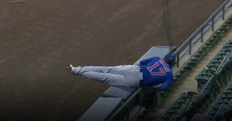 Kris Bryant tumbled over the partition in foul ground at Miller Park, ending his futile attempt at catching a foul ball.
