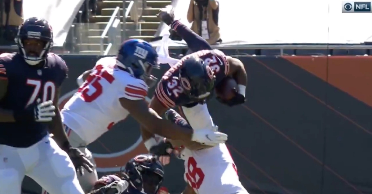 Bears running back David Montgomery's helmet collided with the ground after getting tripped up on a hurdle attempt.