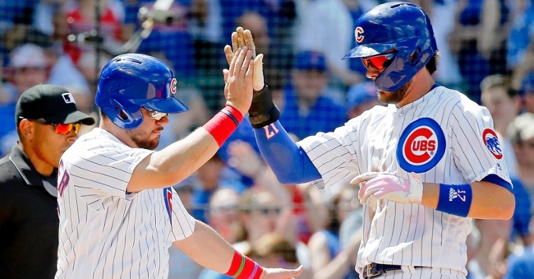 Kris Bryant gifted Kyle Schwarber with a handful of candy in Schwarber's return to the Friendly Confines. (Credit: Jon Durr-USA TODAY Sports)