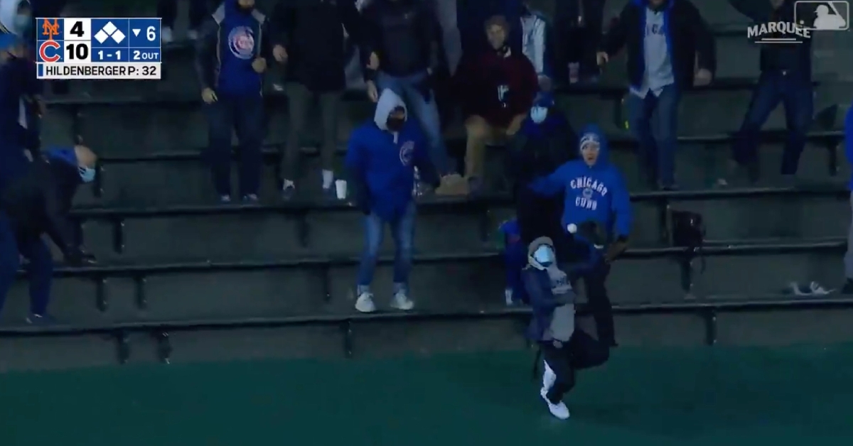 Attempting to catch a grand slam hit by Javier Baez led to this fan going for a slide.