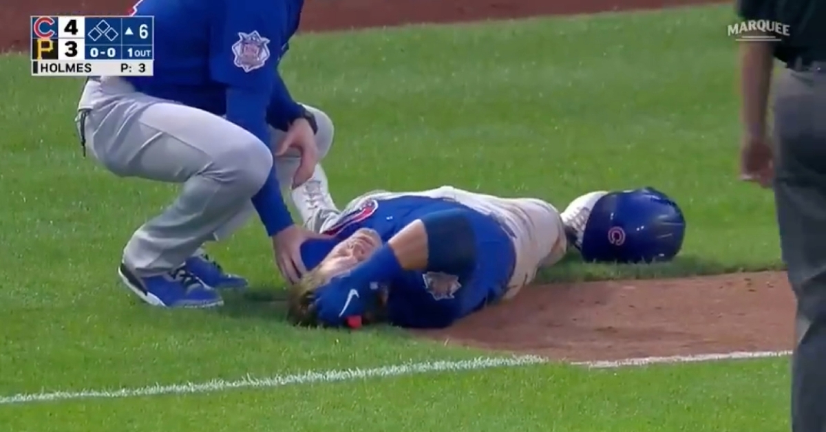 Nico Hoerner immediately dropped to the ground in pain after stretching out at first base in an attempt at beating a throw.